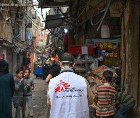 A MSF staff worker stands in a refugee camp in South Beirut, Lebanon