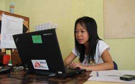 An MSF HR administrator working at a computer.