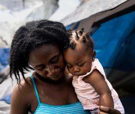A woman holds her baby daughter in Mexico. 