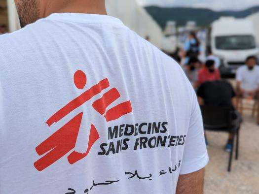 Person wearing a white T-shirt with Doctors Without Borders logo on the back