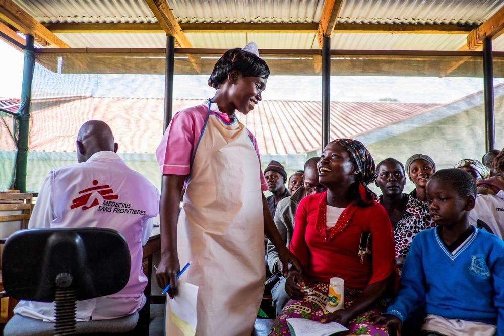 In the HIV department of Arua Regional hospital-Uganda, a patient and MSF staff member smile at one another warmly