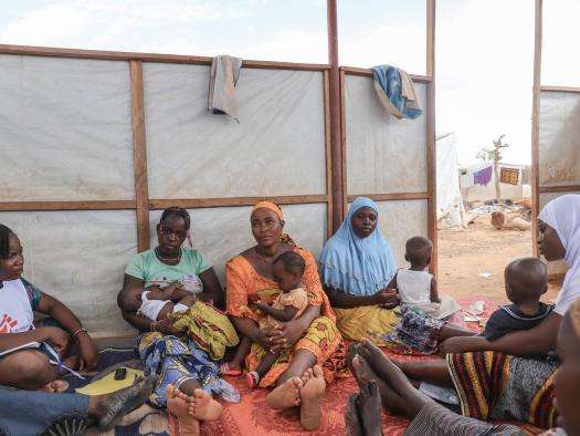 Mothers and their children in a women's club session in an IDP camp in Kongoussi, Burkina Faso