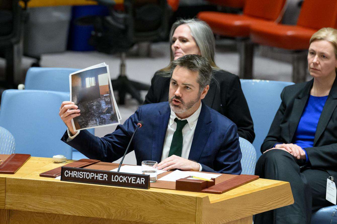 Christopher Lockyear, secretary general of Médecins Sans Frontières (MSF), holds up an image of the destroyed MSF shelter in Al-Mawasi in Khan Younis, Gaza, at a UNSC briefing.