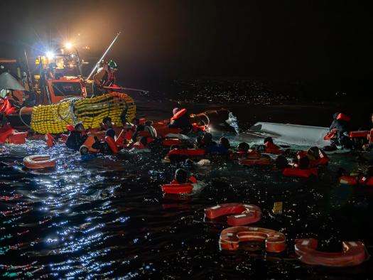 MSF search and rescue teams rescue migrants from a capsized boat in the Central Mediterranean.