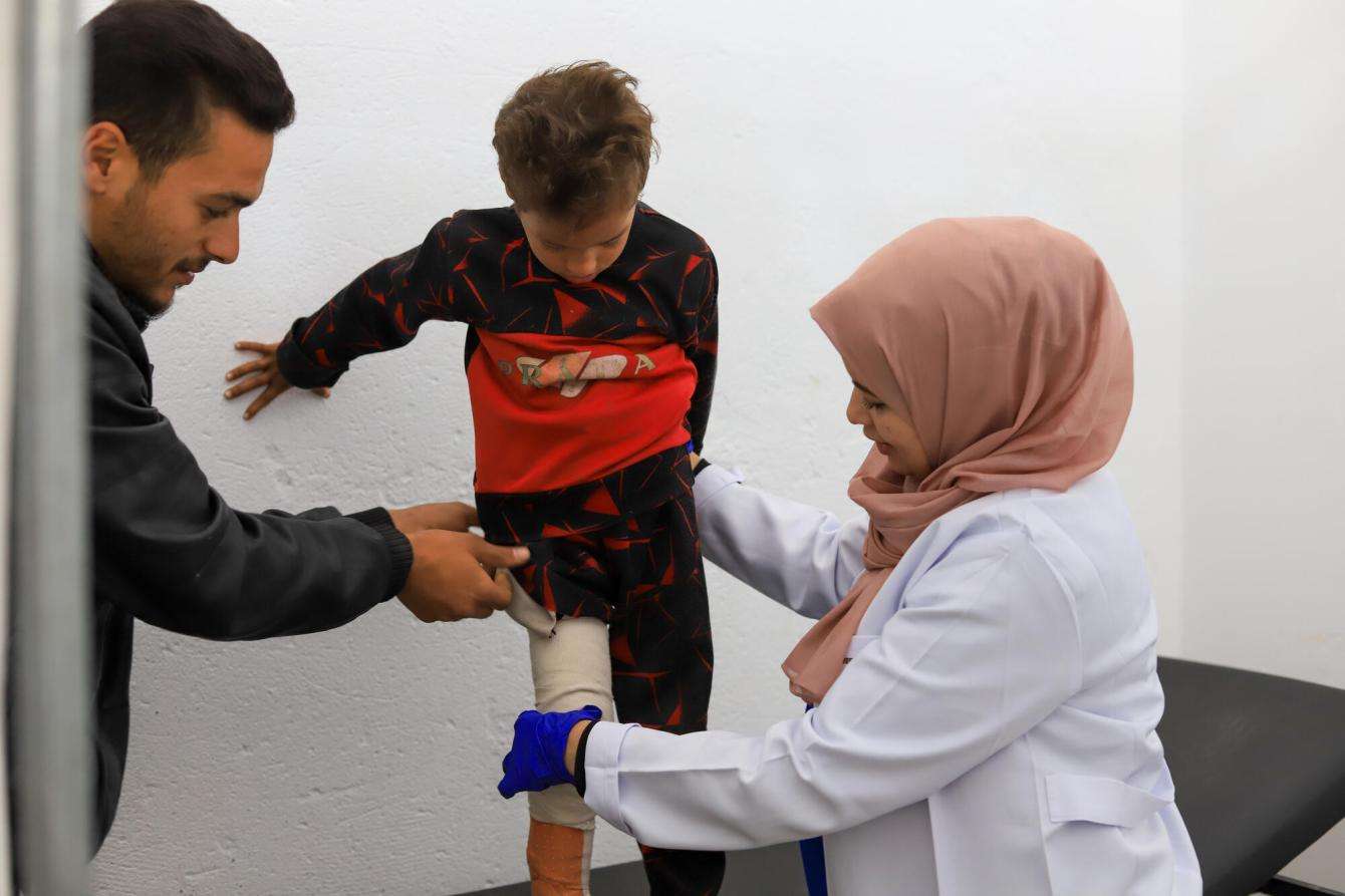 MSF physiotherapist Mia is conducts a physiotherapy session with a 6-year-old boy in Health Post run by MSF in Al Mawasi, Gaza Strip.