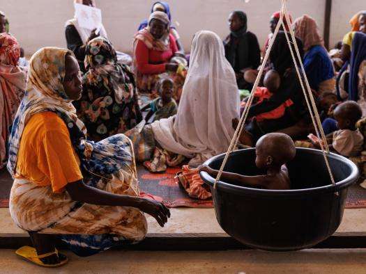 Children arrive with their mothers and are weighed as part of a process that checks for malnutrition inside the Médecins Sans Frontières, (MSF) clinic at a refugee transit camp on April 25, 2024 in Adre, Chad.
