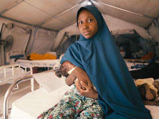 Maryam holds her newborn in a hospital in Nigeria. 