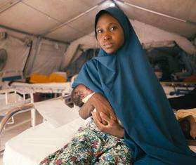 Maryam holds her newborn in a hospital in Nigeria. 