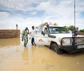 MSF staff drive a vehicle through flood water in Mali. 