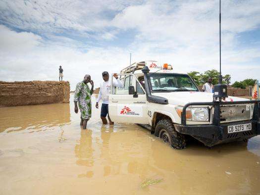 MSF staff drive a vehicle through flood water in Mali. 