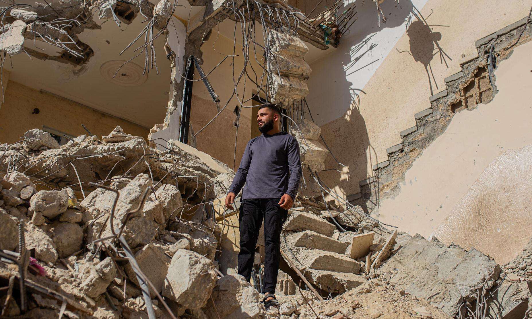 A Palestinian man stands in the rubble of his home after it was bulldozed by Israeli forces in Jenin refugee camp.
