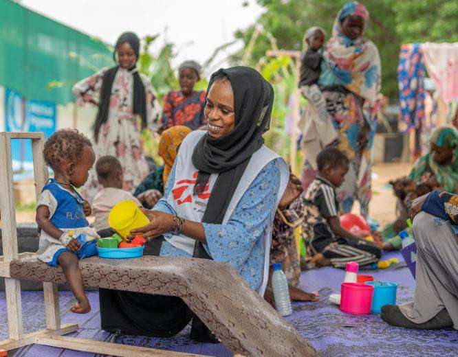 Mental health activity manager Saidi Nabiha and her colleague Zamzam, a Sudanese counselor, provide physiotherapeutic care to patients in the malnutrition ward to counteract developmental delays arising from malnutrition. 