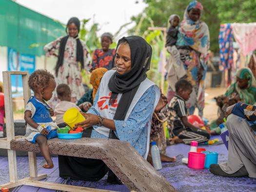 Mental health activity manager Saidi Nabiha and her colleague Zamzam, a Sudanese counselor, provide physiotherapeutic care to patients in the malnutrition ward to counteract developmental delays arising from malnutrition. 