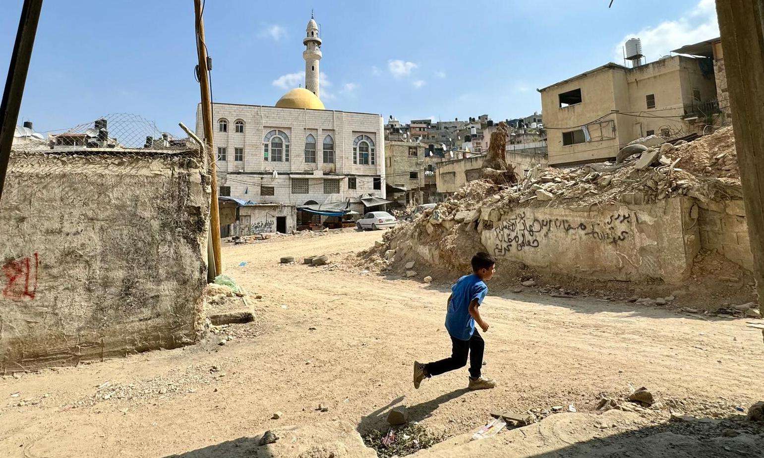 A child runs through Nur Shams refugee camp in Tulkarem.
