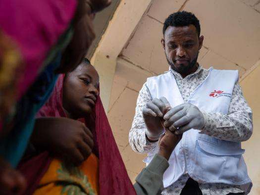 An MSF nurse performs a rapid malaria test on a girl in Ethiopia. 