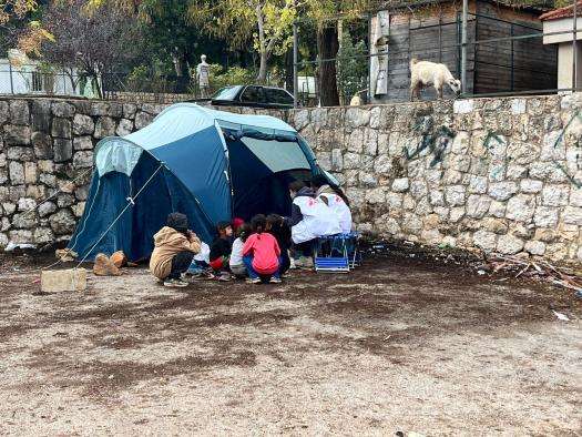 Lebanese family in a tent being visited by MSF workers. 