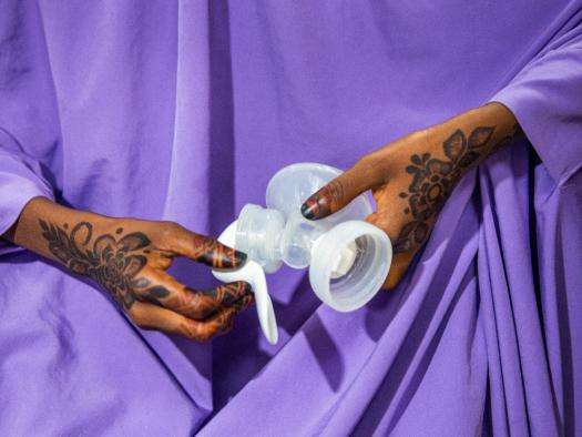 A new mother hold a breast pump in Nigeria. 