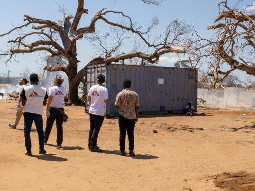 MSF workers survey a damaged health center in Mozambique. 