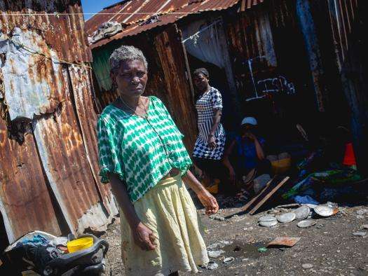A woman stands in Brooklyn, Haiti