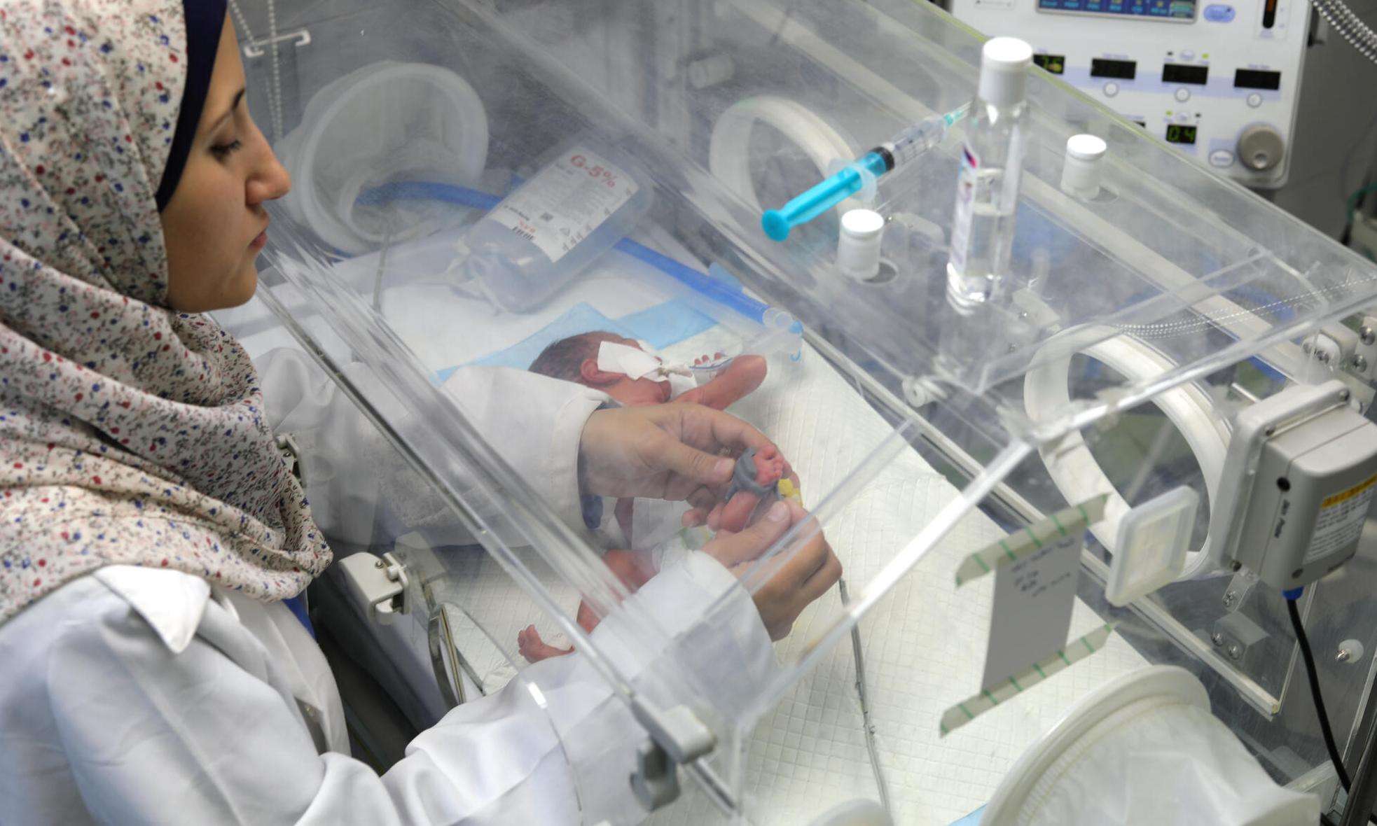 A nurse treats a newborn in Gaza. 