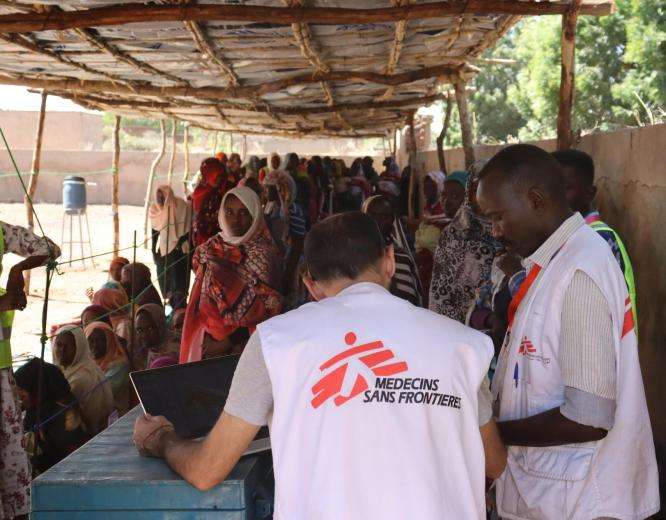 People line up for food distribution in South Darfur, Sudan 