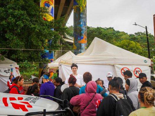 Migrants wait next to the US border in Mexico. 