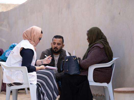MSF staff speak with migrants in Libya.