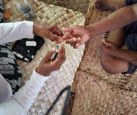 MSF midwife Esther Karume screens a woman for diabetes in Kiribati, an island nation with high rates of the disease.