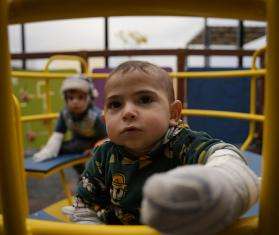 Children receiving care for burns at MSF's hospital in Atmeh play in the recreation area.