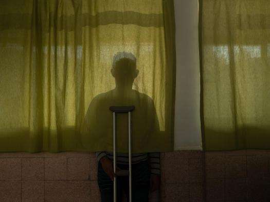 Shadow of a person with crutches in Mexico City.