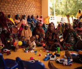 Mothers and children attend a health promotion session in Nigeria. 