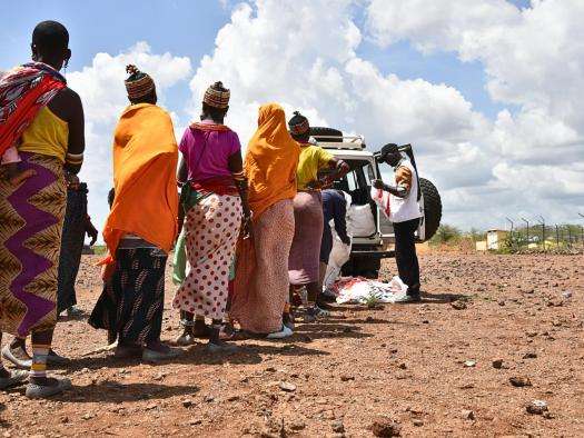 People line up to get a mosquito net in Kenya. 