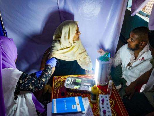 A health worker tests a woman for hepatitis C in Bangladesh. 
