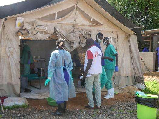 MSF staff stand outside a cholera treatment center in South Sudan. 
