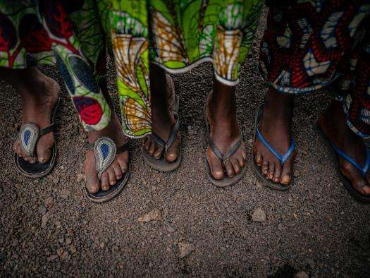 Patients who are survivors of sexual violence visit an MSF nurse at a triage tent in Goma, DRC.