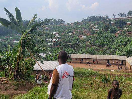 MSF staffer looks at hillside in DRC Congo. 