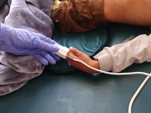 A nurse checks vital signs for a pediatric patient in Yemen. 