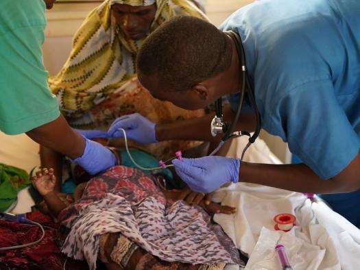 Doctors care for a malnourished child in Somalia. 