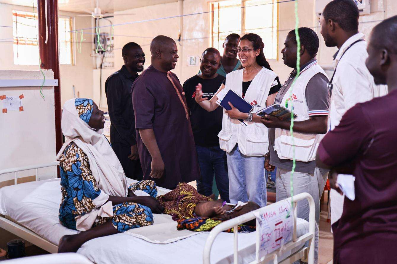MSF Belgium president Katrin Kisswani speaks with a mother whose child is being treated for malnutrition in the emergency room of the inpatient therapeutic feeding center in the Maiyama local government area of Kebbi state.