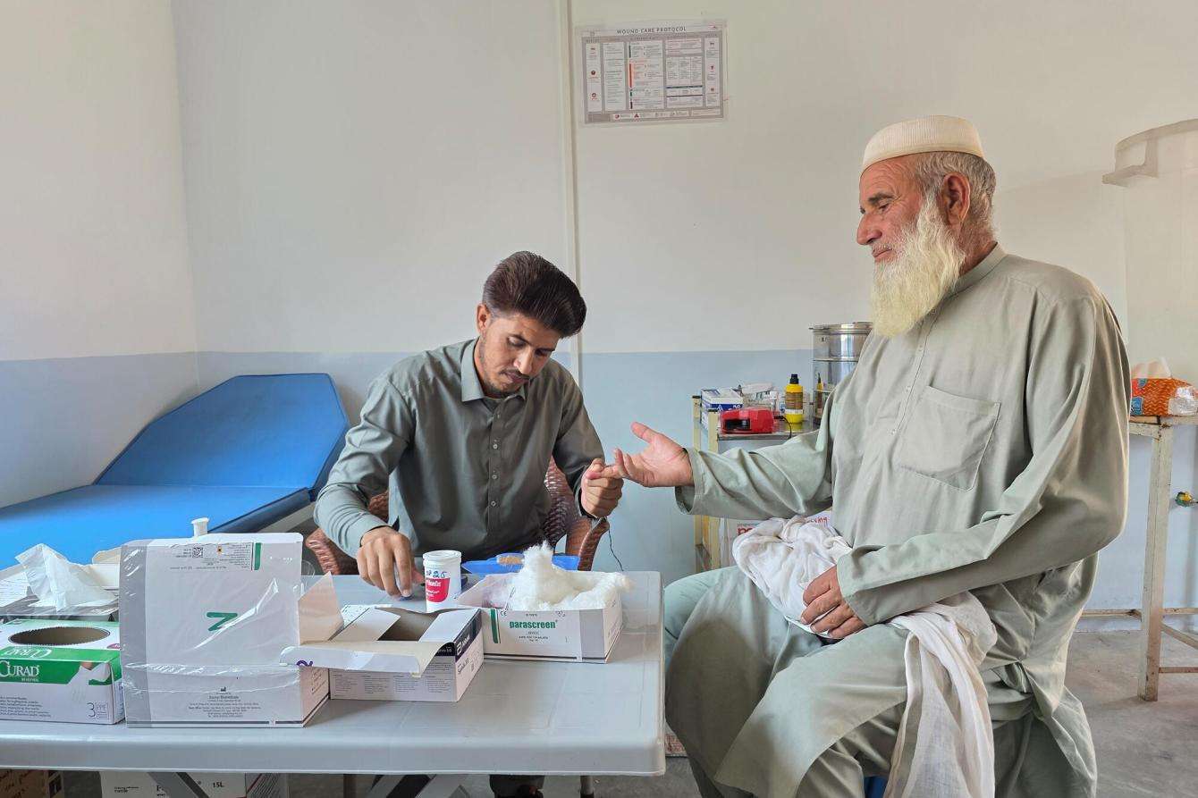A nurse checks a patient's blood sugar in Pakistan