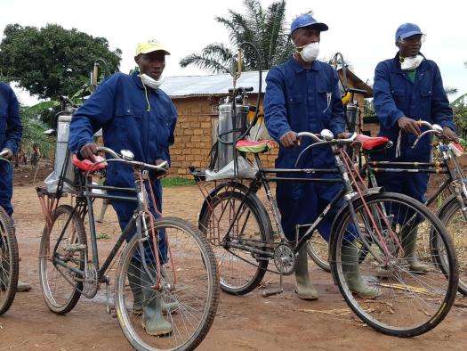 An MSF spraying team arrives in a village to treat houses against mosquitoes