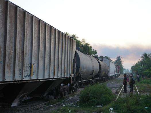 Migrants in the City of Coatzacoalcos jump on a train