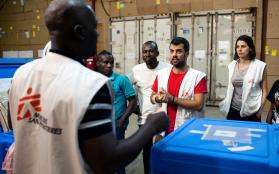 MSF supply logisticians planning their work in an office.