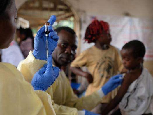 A health worker from the Congolese Ministry of Health prepares to administer a measles vaccine.