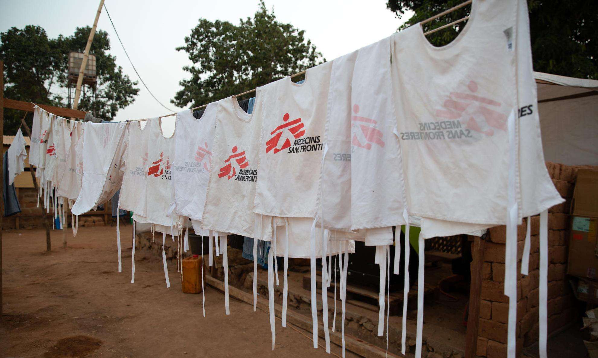 White vests with MSF logo hanging on a clothesline