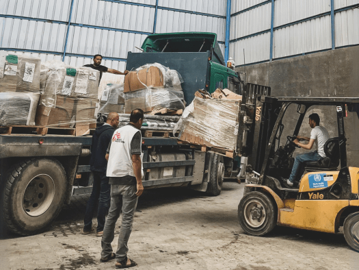 MSF staff with medical supplies in a warehouse in Gaza.