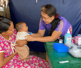 MSF teams check a baby while responding to the Myanmar earthquake.