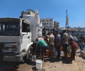 Palestinians queue for water outside an MSF water truck in Gaza.